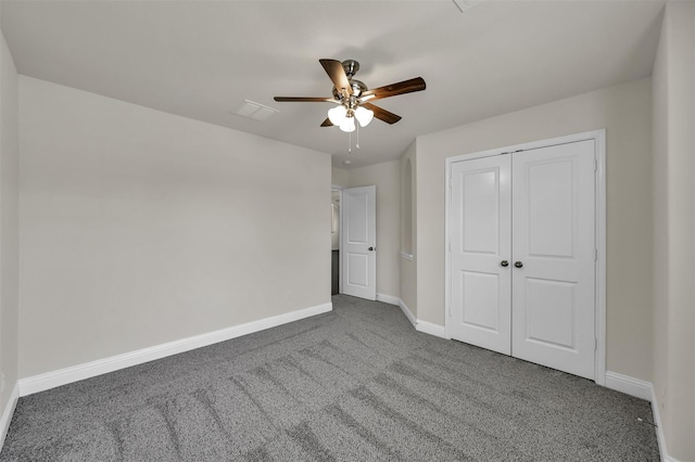 unfurnished bedroom featuring ceiling fan, a closet, and dark carpet