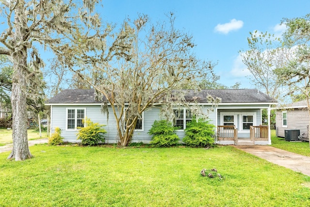 single story home with a front lawn, cooling unit, and a porch