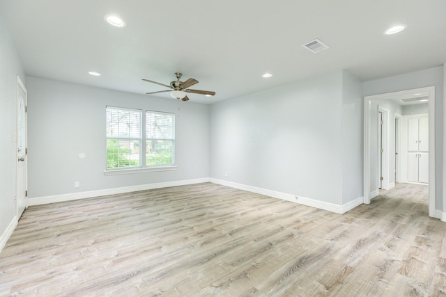 spare room featuring ceiling fan and light hardwood / wood-style flooring