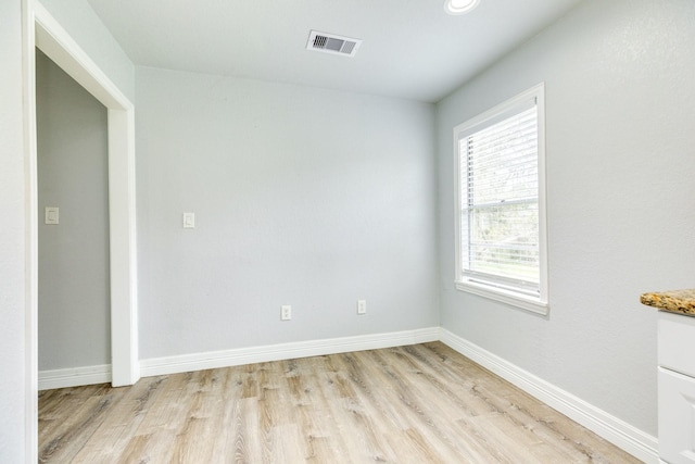 empty room with light hardwood / wood-style floors