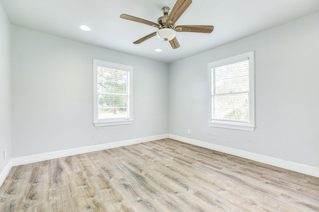 unfurnished room featuring light wood-type flooring, plenty of natural light, and ceiling fan