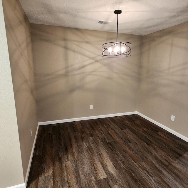 unfurnished dining area with a textured ceiling and hardwood / wood-style flooring