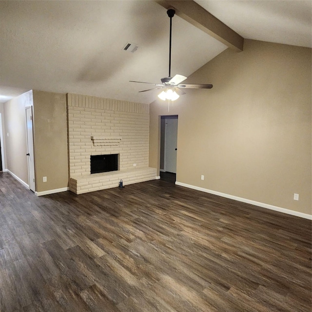 unfurnished living room with a brick fireplace, ceiling fan, dark hardwood / wood-style floors, and vaulted ceiling with beams