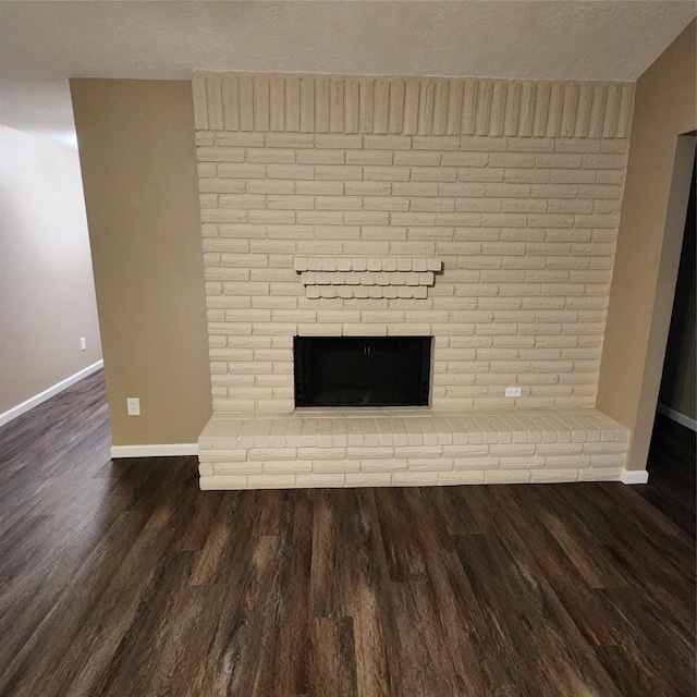 interior details featuring a fireplace and wood-type flooring