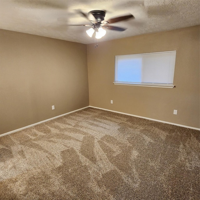 empty room featuring carpet flooring, a textured ceiling, and ceiling fan