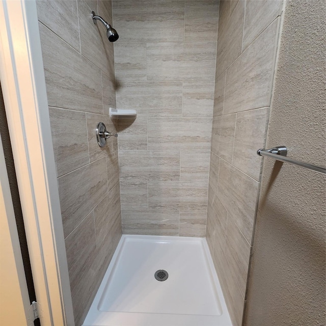 bathroom with a tile shower