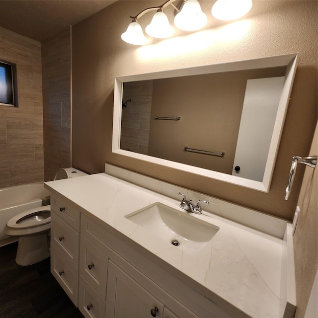 full bathroom with toilet, vanity, and tiled shower / bath