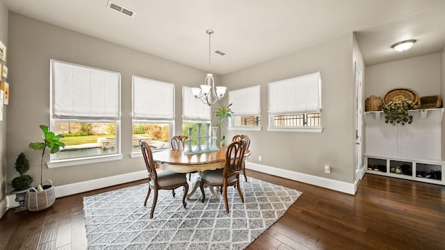 dining room featuring dark hardwood / wood-style floors and a chandelier