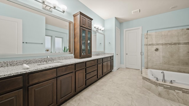 bathroom featuring vanity and shower with separate bathtub