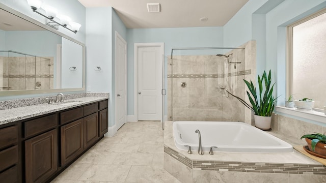 bathroom with vanity and independent shower and bath