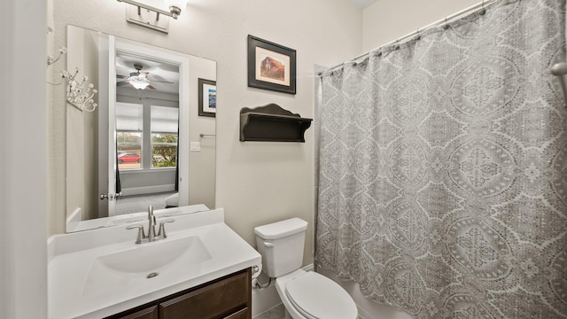 bathroom featuring vanity, a shower with shower curtain, ceiling fan, and toilet