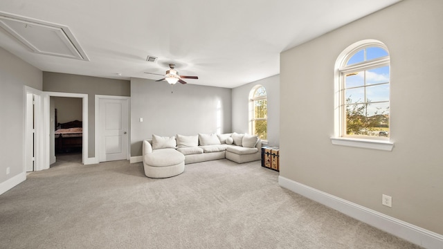 carpeted living room featuring ceiling fan