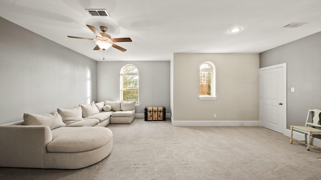 carpeted living room featuring ceiling fan