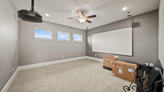 home theater with ceiling fan and carpet flooring