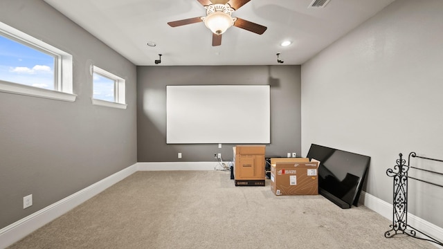 carpeted home theater room featuring ceiling fan