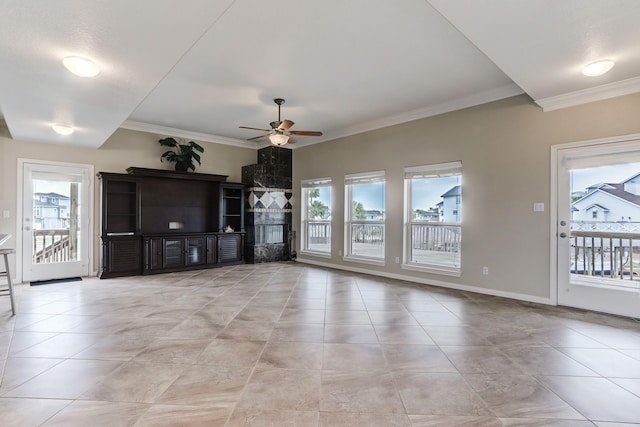 unfurnished living room featuring ceiling fan, crown molding, and a wealth of natural light