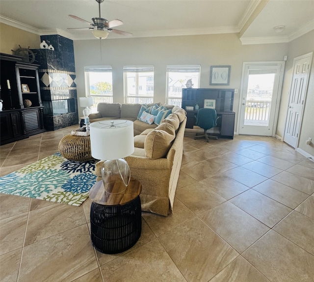 tiled living room with ceiling fan and crown molding