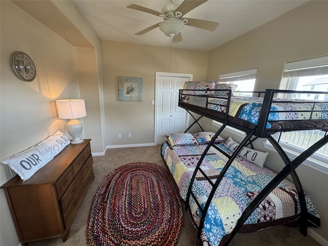 carpeted bedroom with a closet and ceiling fan