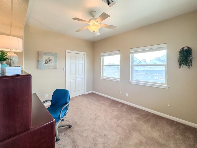 carpeted office featuring ceiling fan