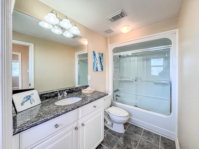 full bathroom featuring vanity, toilet, enclosed tub / shower combo, and a textured ceiling