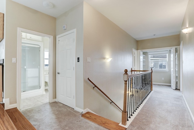 corridor featuring light colored carpet