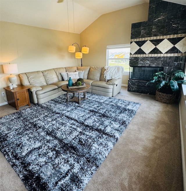 living room with carpet, lofted ceiling, and a tiled fireplace