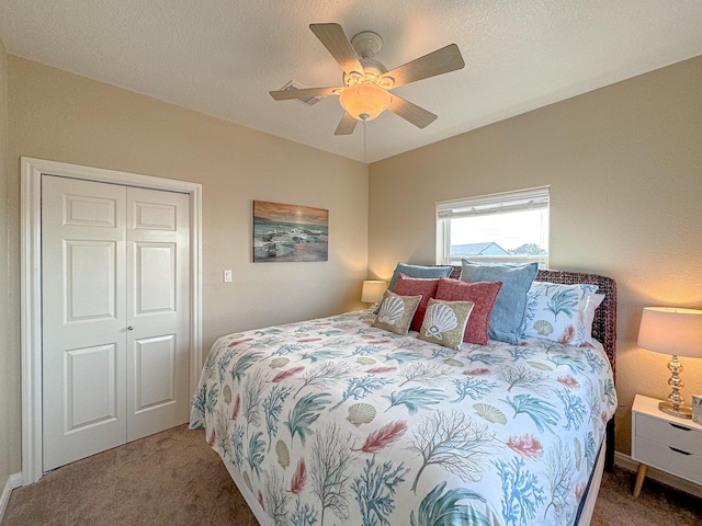 bedroom featuring ceiling fan, a closet, and dark carpet