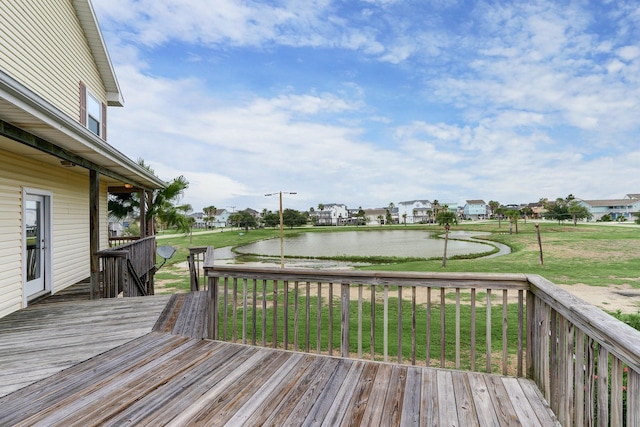 wooden deck with a water view and a yard