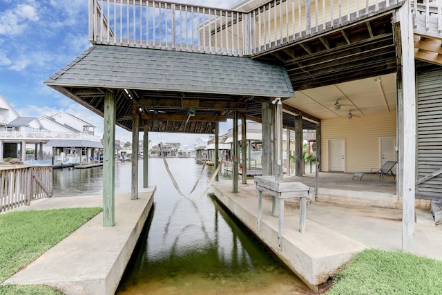 dock area featuring a patio area and a water view