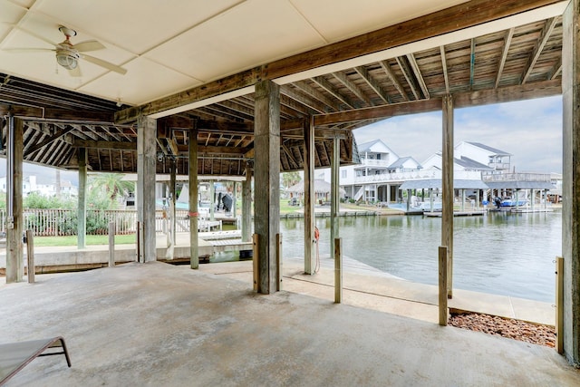 exterior space with ceiling fan and a water view