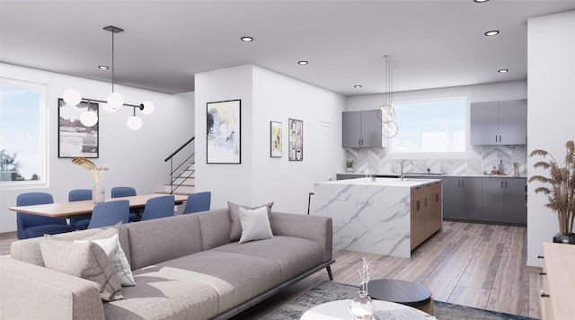 living room featuring light hardwood / wood-style floors and a wealth of natural light