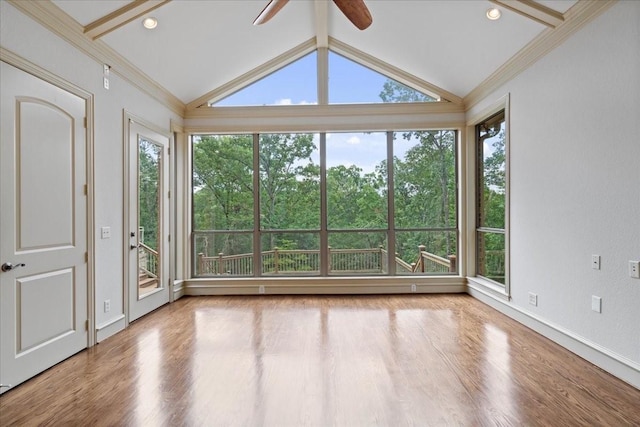 unfurnished sunroom with ceiling fan, plenty of natural light, and vaulted ceiling