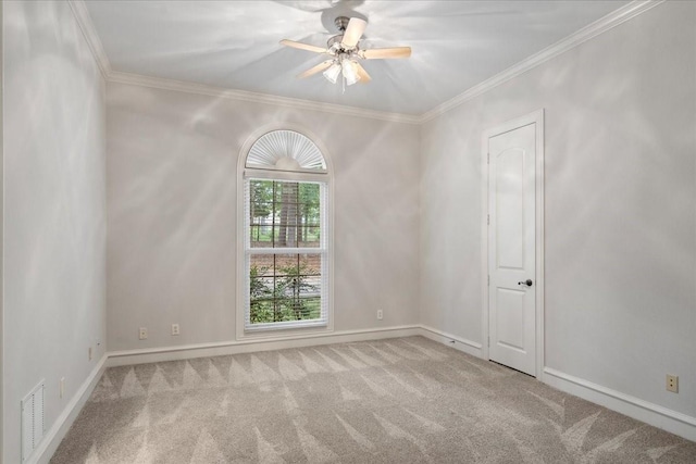 unfurnished room with crown molding, ceiling fan, and light colored carpet