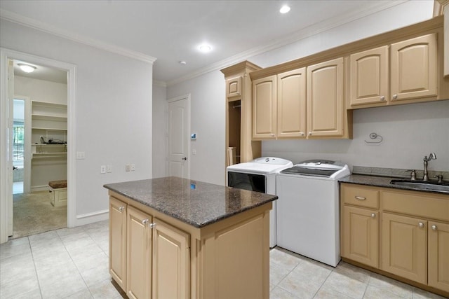 laundry room with cabinets, sink, washer and dryer, ornamental molding, and light tile patterned floors