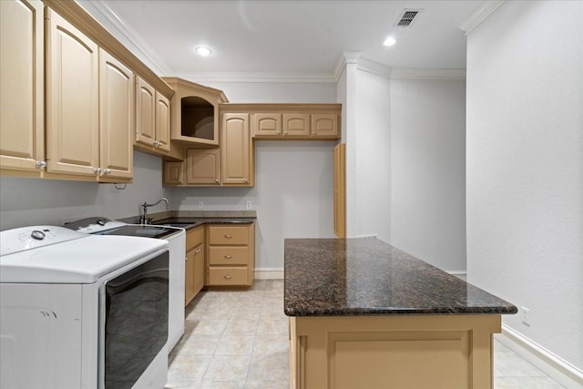 clothes washing area with separate washer and dryer, crown molding, sink, and cabinets