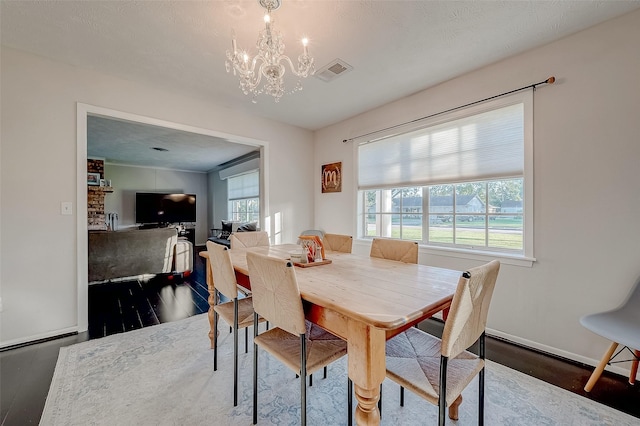 dining space featuring a notable chandelier and dark hardwood / wood-style floors