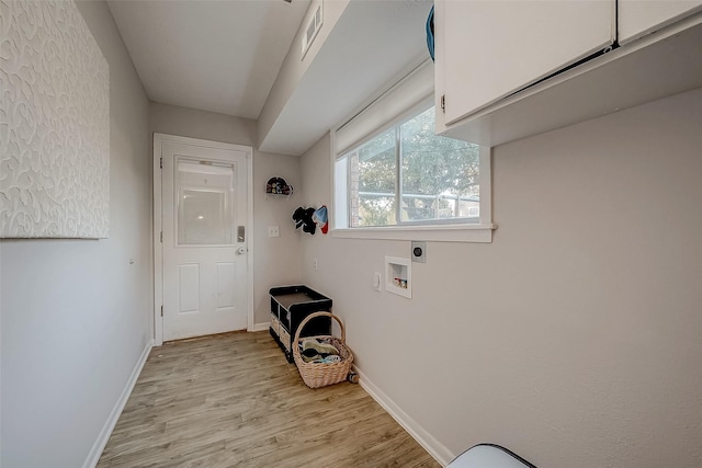 clothes washing area featuring hookup for an electric dryer, cabinets, light wood-type flooring, and washer hookup