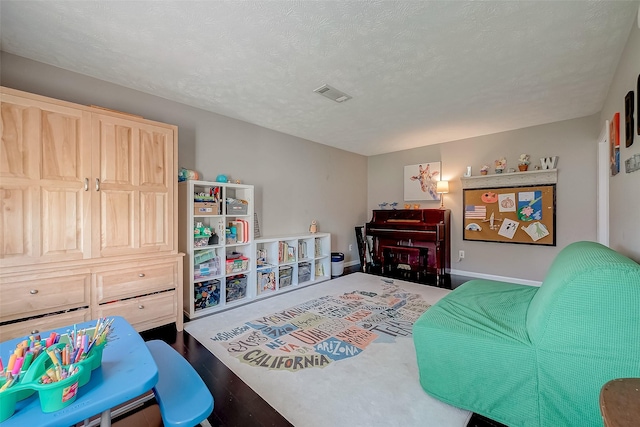 bedroom featuring hardwood / wood-style floors and a textured ceiling