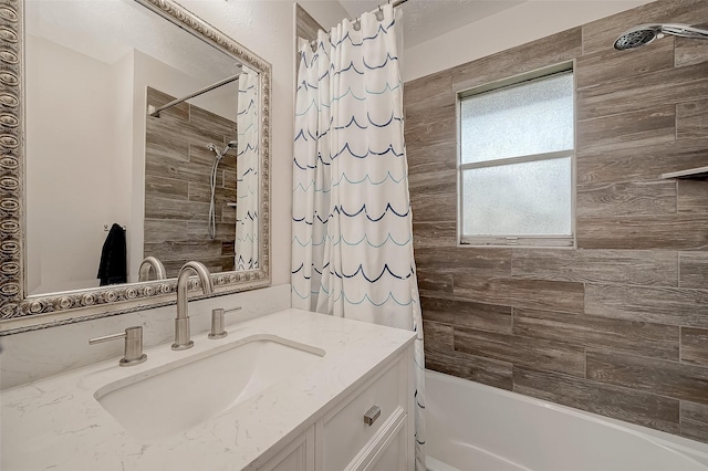 bathroom featuring shower / tub combo and vanity