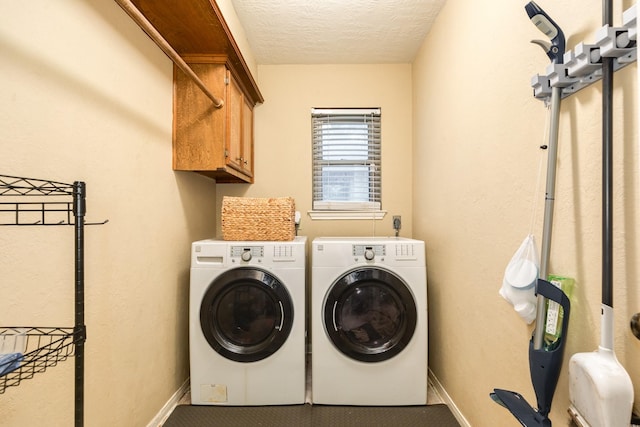 washroom with cabinets, separate washer and dryer, and a textured ceiling