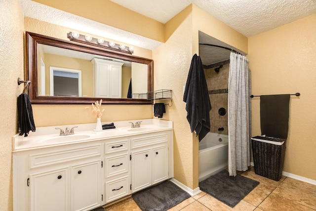 bathroom featuring shower / bath combo with shower curtain, vanity, a textured ceiling, and tile patterned flooring