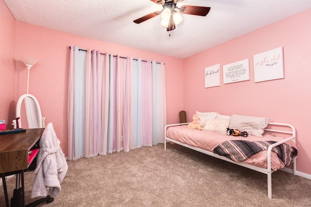 carpeted bedroom with a textured ceiling and ceiling fan