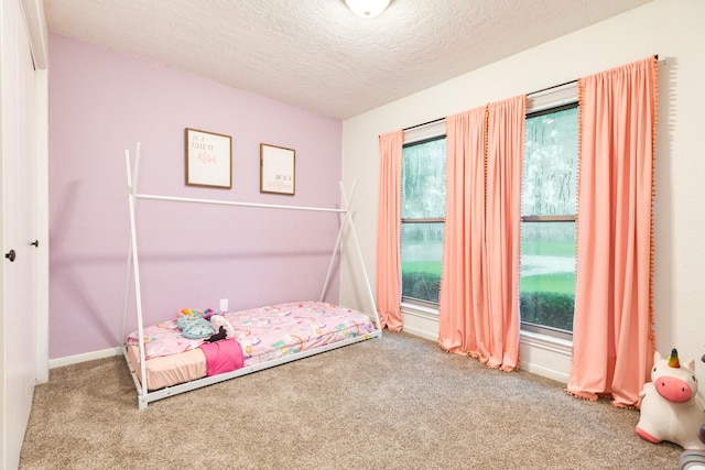 unfurnished bedroom with carpet and a textured ceiling