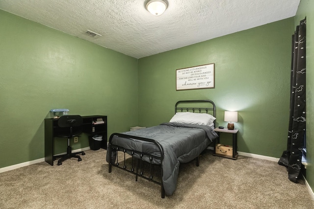 bedroom featuring a textured ceiling and light carpet