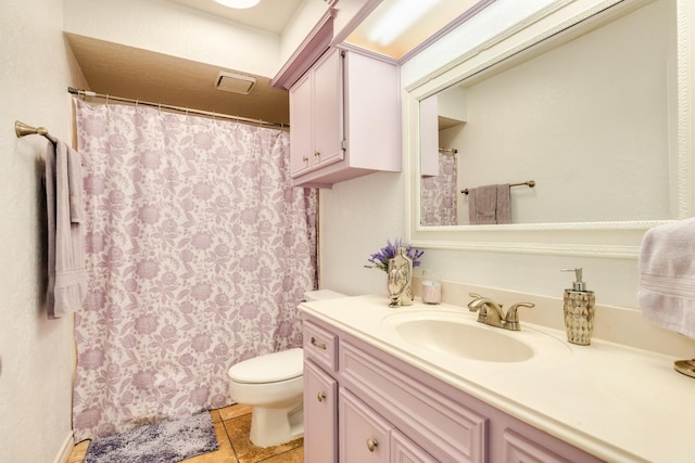 bathroom with tile patterned flooring, vanity, and toilet