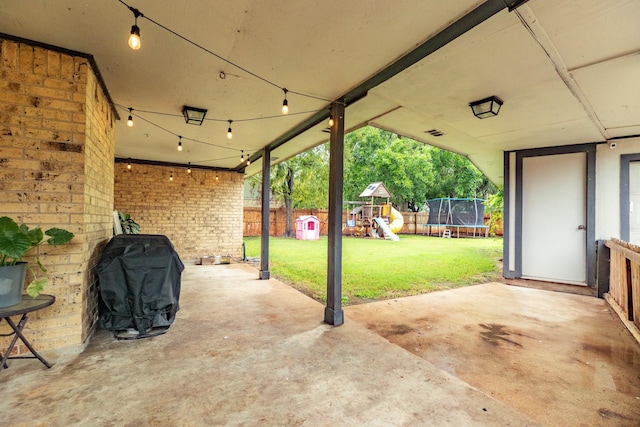 view of patio / terrace featuring a playground, a grill, and a trampoline