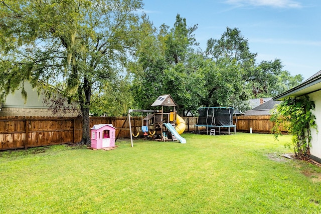 view of yard featuring a playground and a trampoline