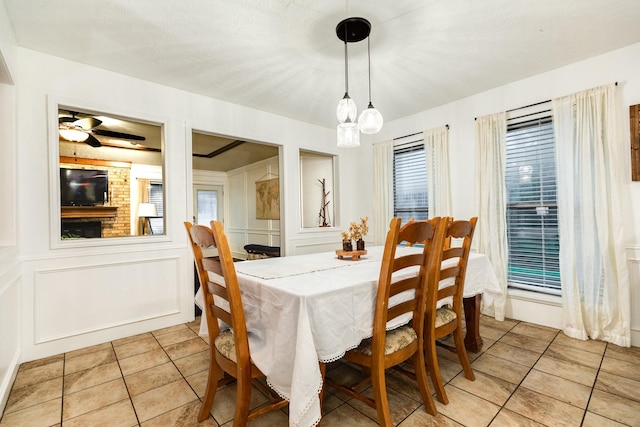 tiled dining area featuring ceiling fan