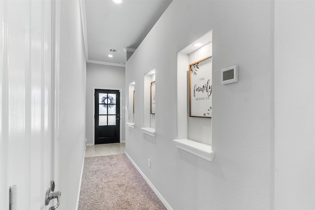 doorway to outside with light carpet and crown molding