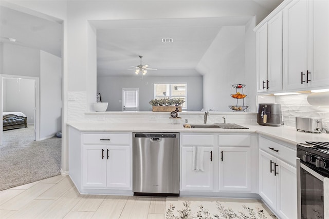 kitchen with white cabinetry, light carpet, sink, and stainless steel dishwasher